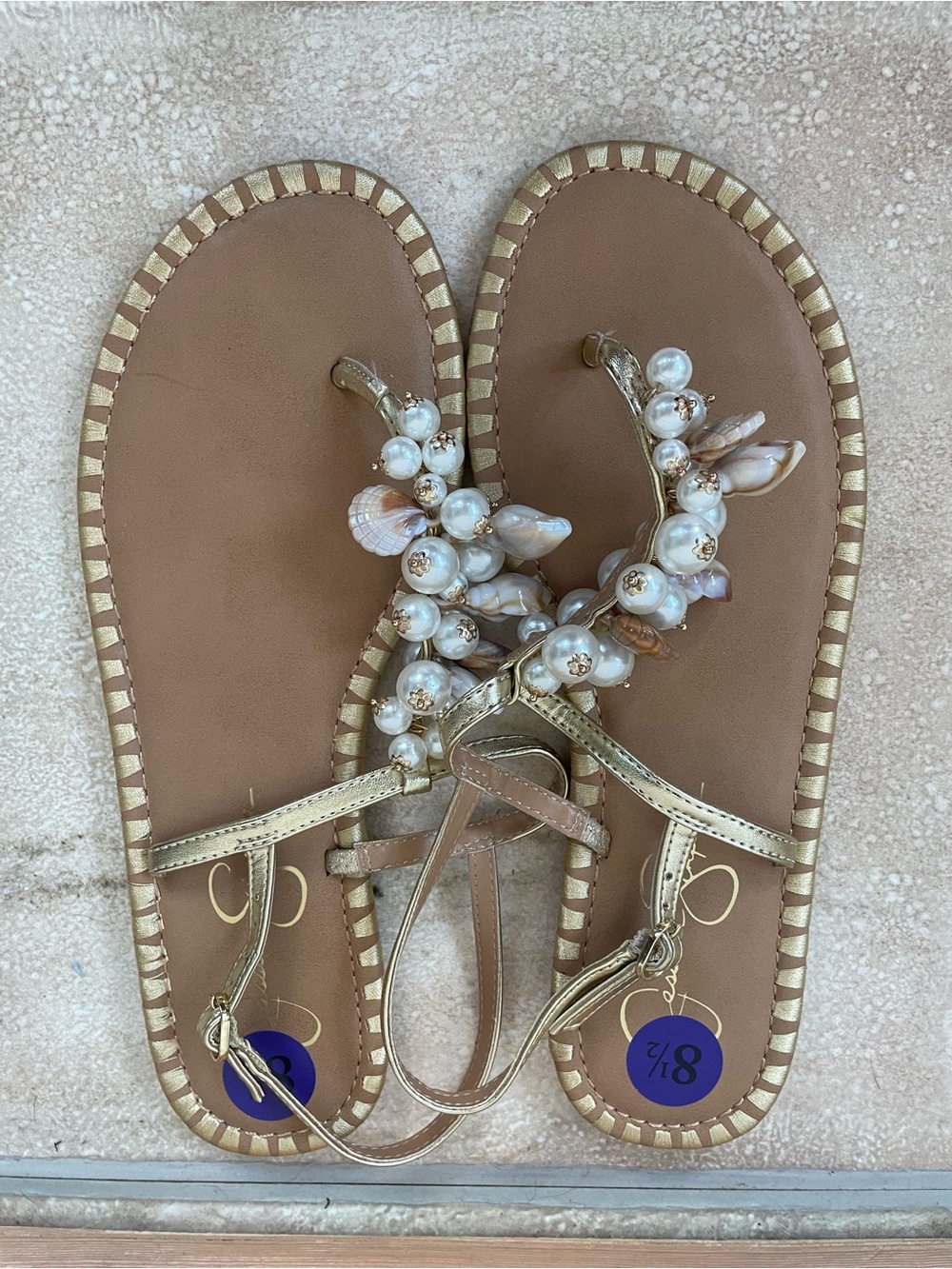 NWOT Jessica Simpson beachy tan / gold thong sandals, shell detail; size 8.5